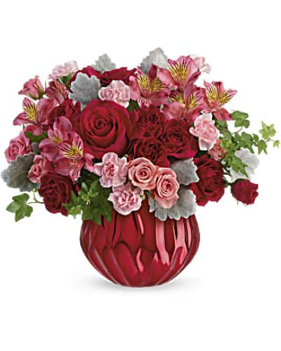 Pure enchantment! Sparkling like a rare gemstone, this alluring ceramic vase has a bold metallic finish that captures the light beneath a lovely red and pink bouquet. Flowers and/or container may be substituted as close as possible if product is out of stock.